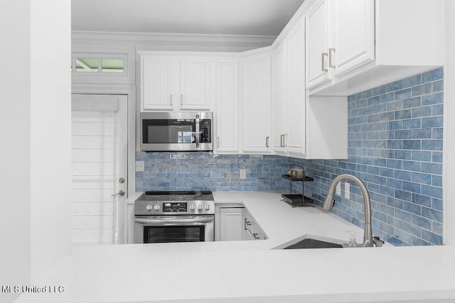 kitchen with white cabinetry, appliances with stainless steel finishes, and sink