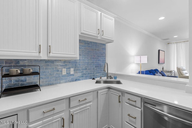 kitchen featuring sink, ornamental molding, white cabinetry, stainless steel dishwasher, and decorative backsplash