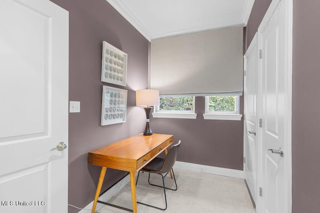 home office with ornamental molding and light colored carpet