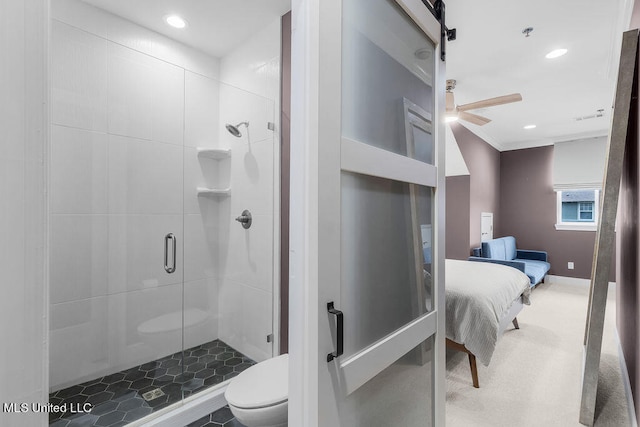 bathroom featuring toilet and a shower with shower door