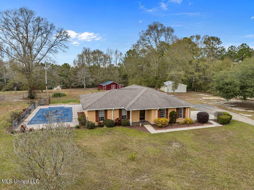 single story home with covered porch and a front yard