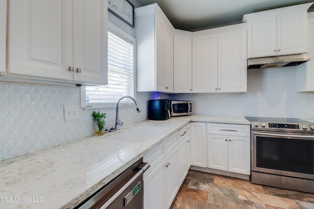 kitchen with a sink, white cabinetry, appliances with stainless steel finishes, and under cabinet range hood