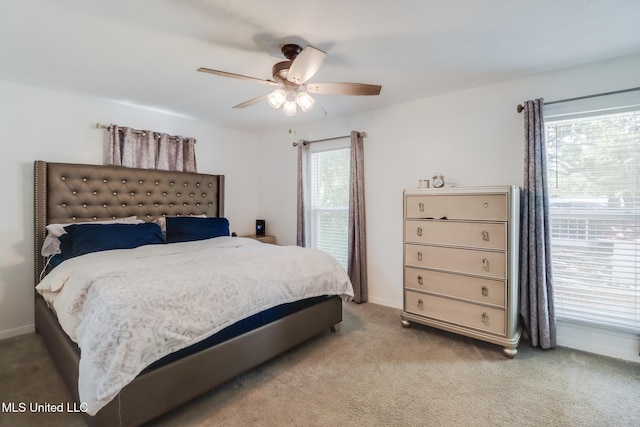 bedroom with baseboards, a ceiling fan, and light colored carpet
