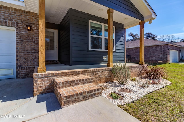 entrance to property with a garage, a porch, and brick siding