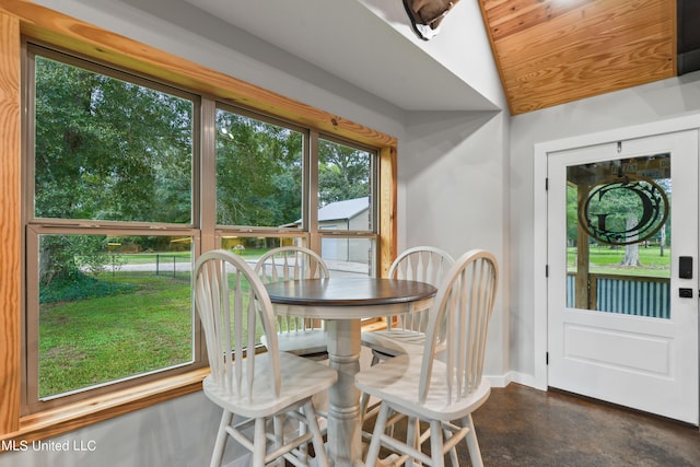 dining area featuring concrete flooring and baseboards