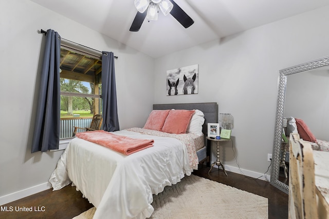 bedroom featuring lofted ceiling, dark wood-type flooring, a ceiling fan, and baseboards