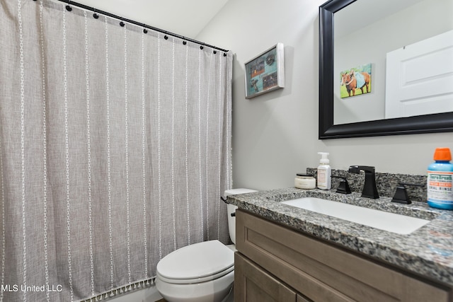 full bath featuring vanity and toilet