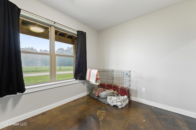 interior space featuring concrete floors and baseboards