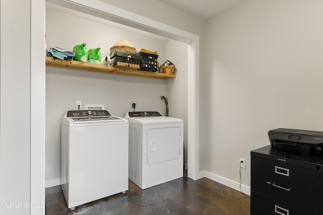 clothes washing area with laundry area, baseboards, and washer and clothes dryer