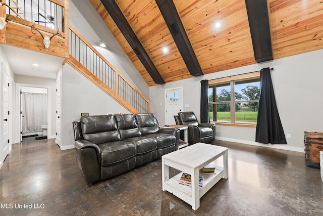 living room featuring high vaulted ceiling, finished concrete floors, beam ceiling, and baseboards