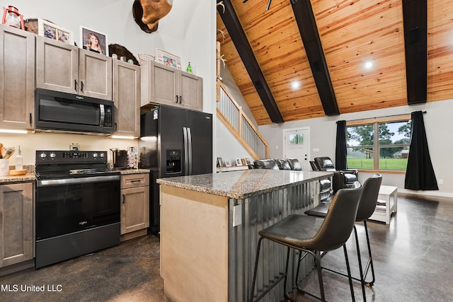 kitchen with concrete floors, range with electric stovetop, a kitchen island, open floor plan, and dark stone countertops