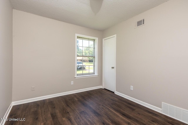 6236 Tulane Rd, Horn Lake, MS 38637 - unfurnished room featuring dark wood-style flooring, baseboards, and a textured ceiling