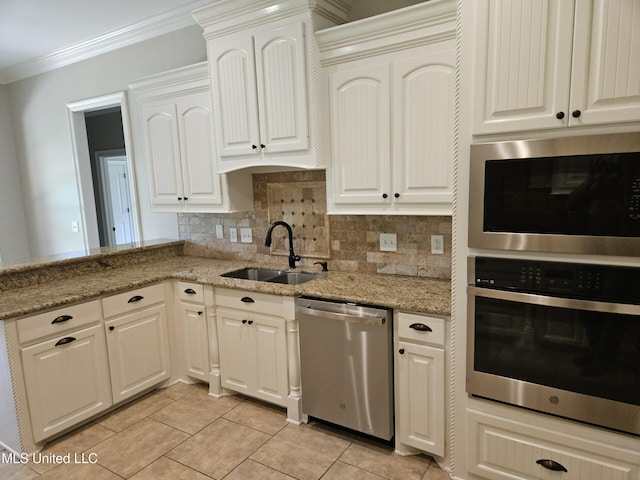 119 Hemlock Ln, Madison, MS 39110 - kitchen with stainless steel appliances, ornamental molding, light tile patterned flooring, backsplash, and light stone counters