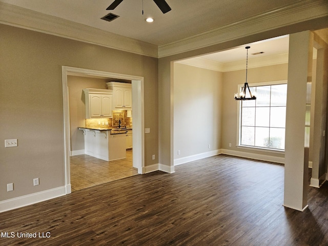 119 Hemlock Ln, Madison, MS 39110 - empty room with crown molding, a ceiling fan, dark wood-style flooring, a chandelier, and recessed lighting