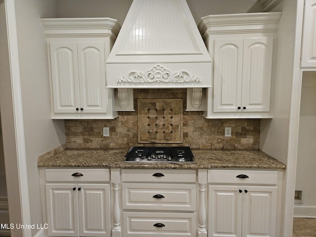 119 Hemlock Ln, Madison, MS 39110 - kitchen with custom range hood, stainless steel gas stovetop, tasteful backsplash, and light stone countertops