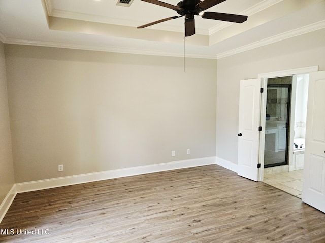 119 Hemlock Ln, Madison, MS 39110 - empty room featuring a tray ceiling, wood finished floors, a ceiling fan, and ornamental molding