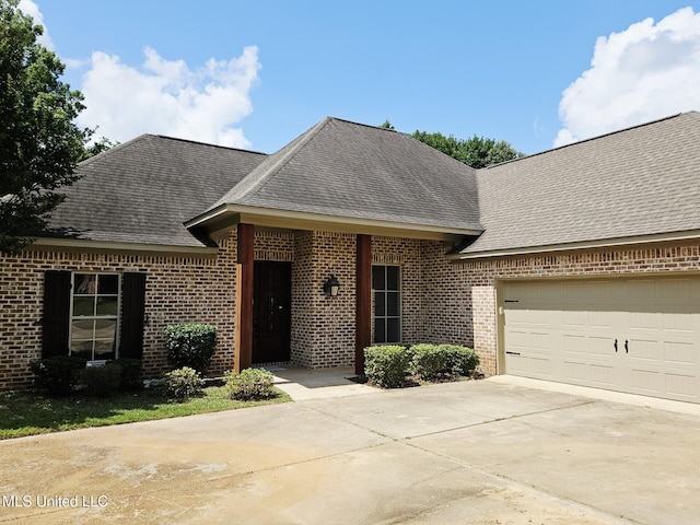 119 Hemlock Ln, Madison, MS 39110 - view of front of home featuring concrete driveway, brick siding, roof with shingles, and an attached garage