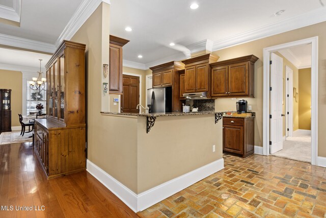 3 Rue Orleans Ct, Long Beach, MS 39560 - dining area with baseboards, brick floors, a chandelier, and crown molding