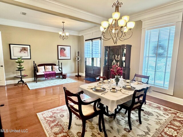 3 Rue Orleans Ct, Long Beach, MS 39560 - dining space featuring a chandelier, plenty of natural light, baseboards, wood finished floors, and crown molding