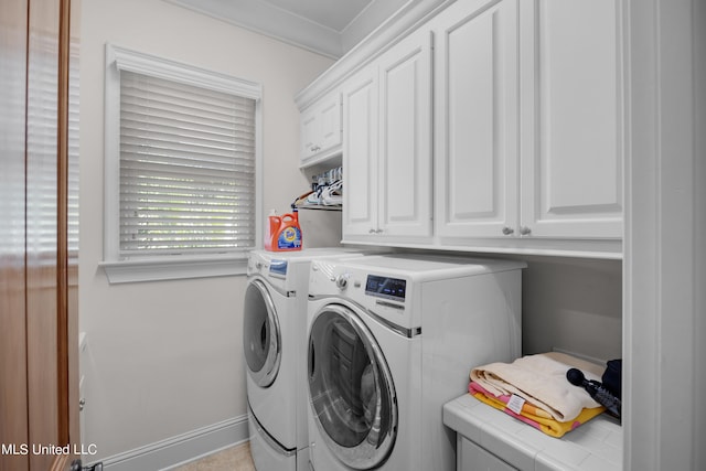 washroom with cabinets, independent washer and dryer, and crown molding