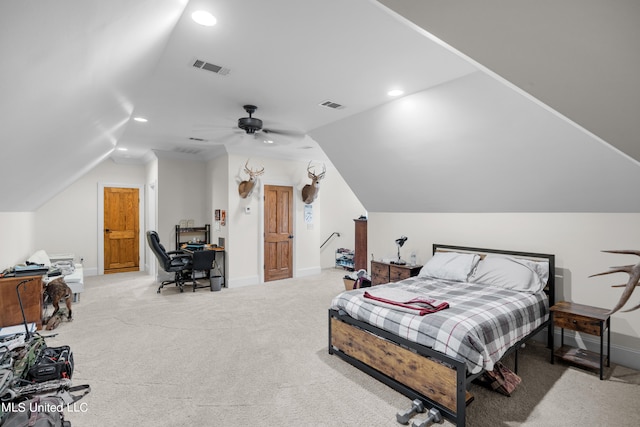 carpeted bedroom with ensuite bath, lofted ceiling, and ceiling fan