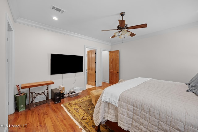 bedroom featuring ceiling fan, wood-type flooring, and ornamental molding