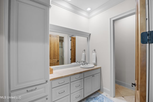 bathroom with vanity, ornamental molding, and tile patterned floors