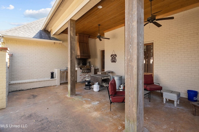 view of patio / terrace featuring area for grilling, ceiling fan, and an outdoor kitchen