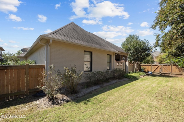 view of side of property featuring a yard