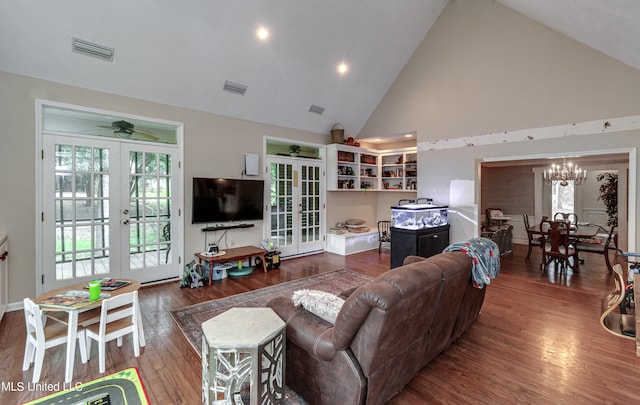 living room with french doors, high vaulted ceiling, dark hardwood / wood-style floors, and ceiling fan with notable chandelier