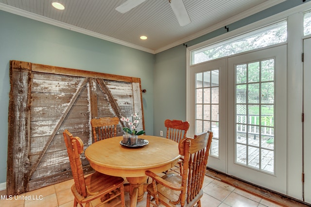 dining space with crown molding, light tile patterned floors, and ceiling fan