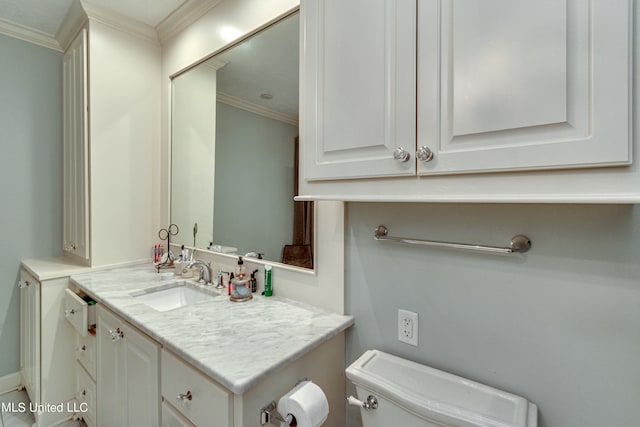 bathroom featuring vanity, crown molding, and toilet