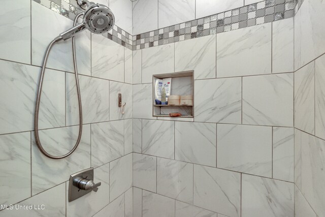 bathroom with a tile shower