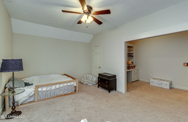 carpeted bedroom featuring a closet, vaulted ceiling, and ceiling fan