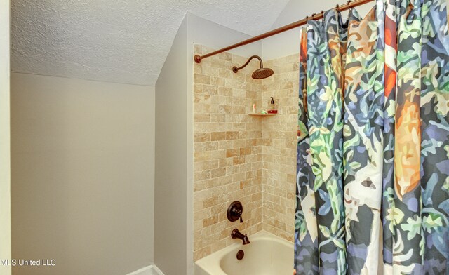 bathroom featuring a textured ceiling, shower / bath combo, and vaulted ceiling