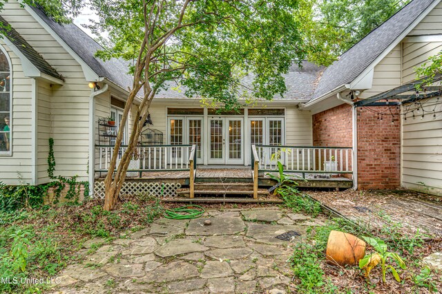 back of property featuring a wooden deck