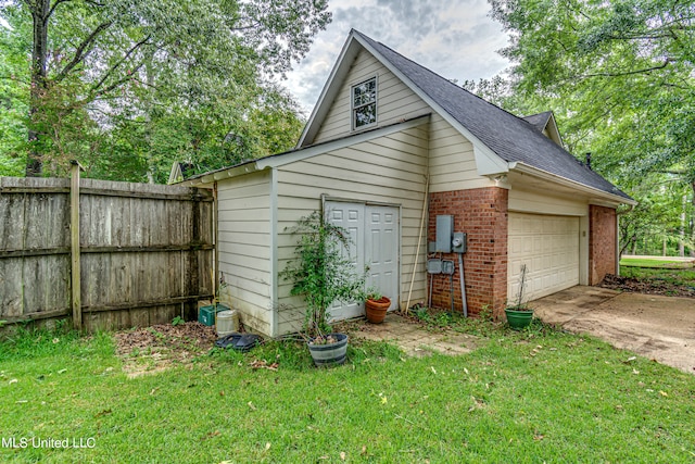 exterior space featuring a garage and a lawn