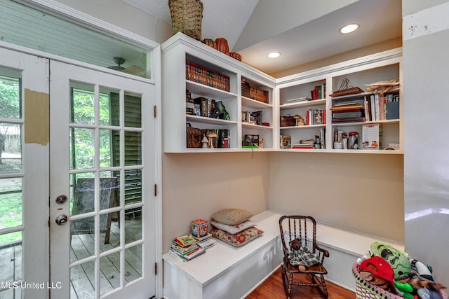 interior space featuring lofted ceiling, french doors, hardwood / wood-style flooring, and a textured ceiling