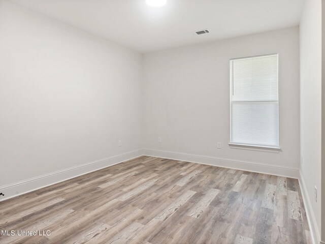 spare room with light hardwood / wood-style flooring