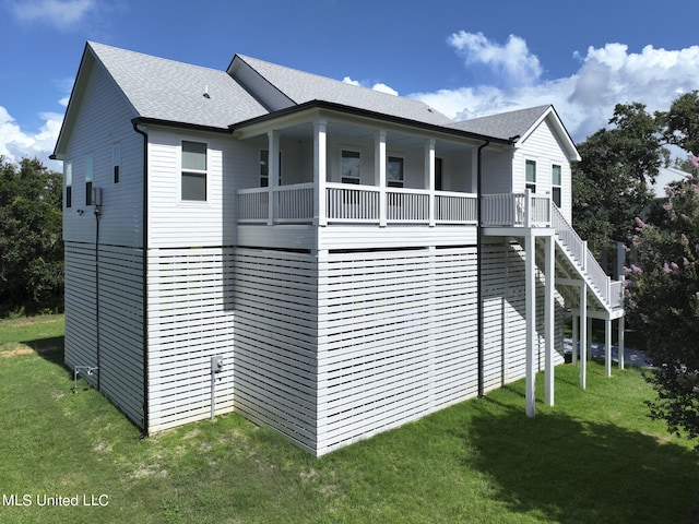 view of home's exterior featuring a lawn and a balcony