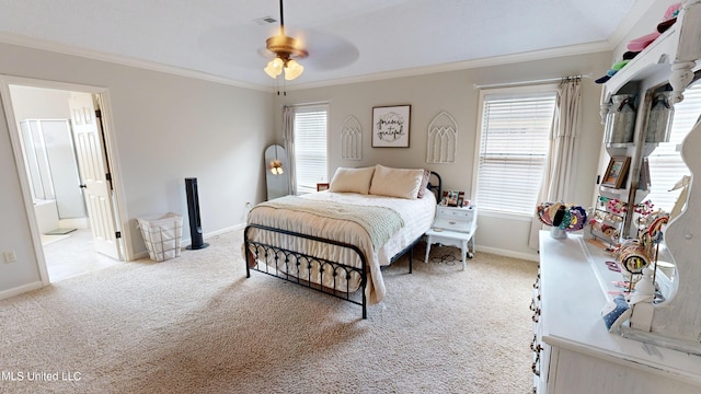 bedroom with baseboards, crown molding, and carpet