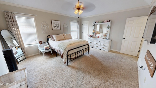 carpeted bedroom featuring ceiling fan, baseboards, and ornamental molding