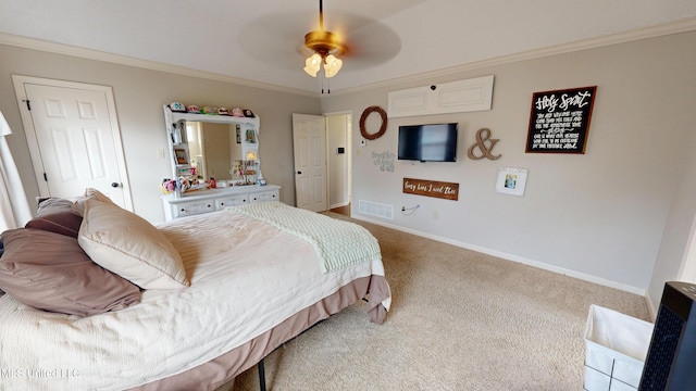 carpeted bedroom featuring ceiling fan, baseboards, visible vents, and ornamental molding