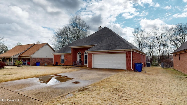 view of front of home featuring brick siding, a shingled roof, concrete driveway, a chimney, and an attached garage