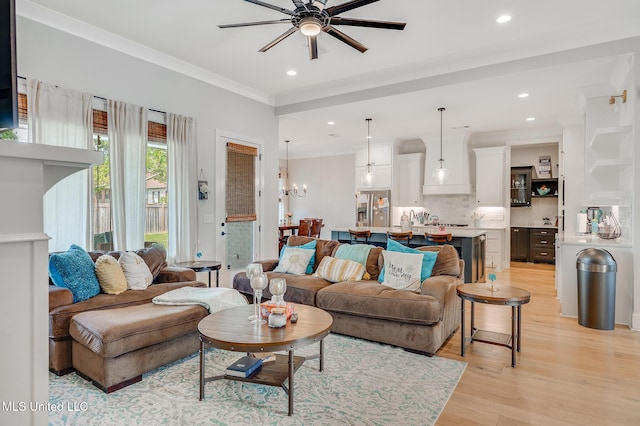 101 Coventry Ln, Canton, MS 39046 - living room with recessed lighting, light wood finished floors, ornamental molding, and ceiling fan with notable chandelier