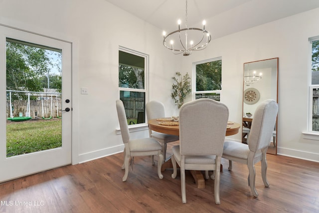 dining room with a notable chandelier and dark hardwood / wood-style floors