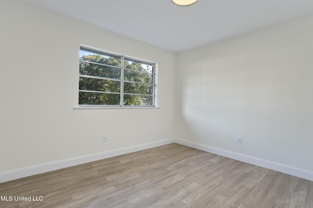 empty room with light hardwood / wood-style floors