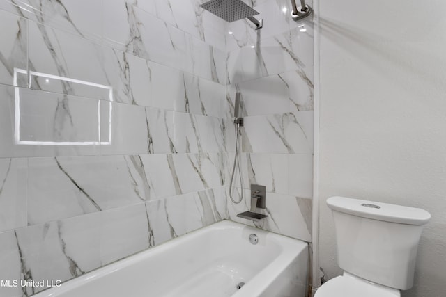 bathroom featuring toilet and tiled shower / bath