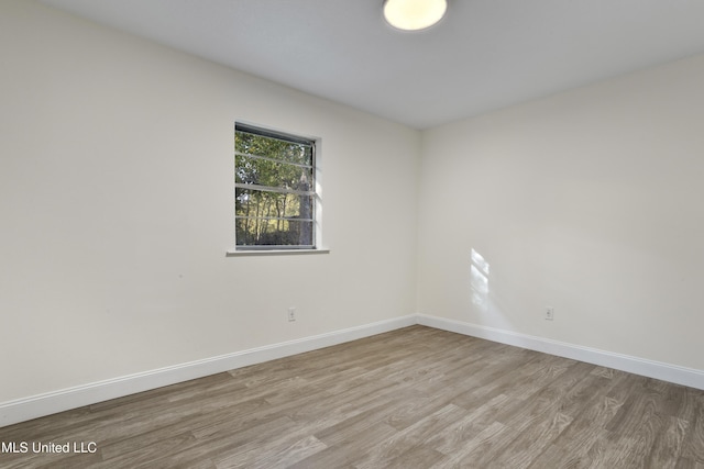 empty room with light hardwood / wood-style flooring