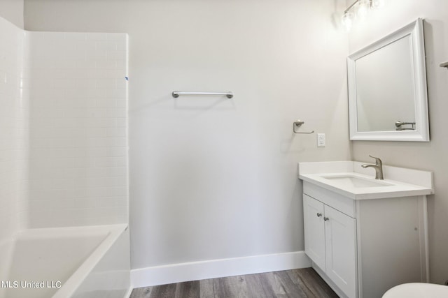 bathroom with wood-type flooring, vanity, and shower / bathing tub combination